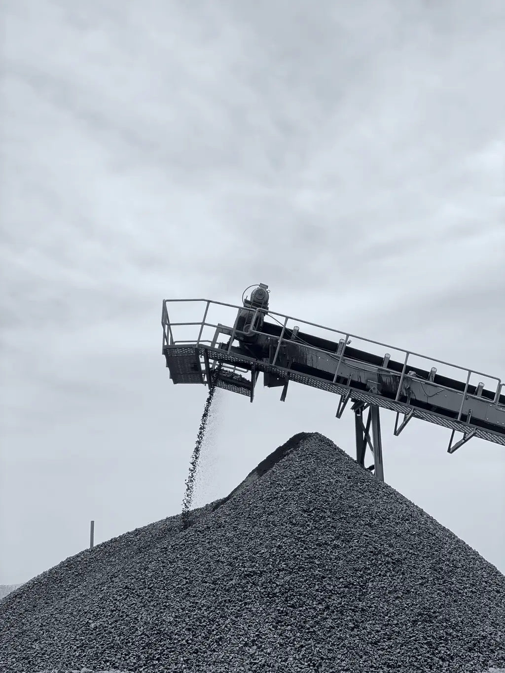 Conveyor discharging crushed ore onto a stockpile