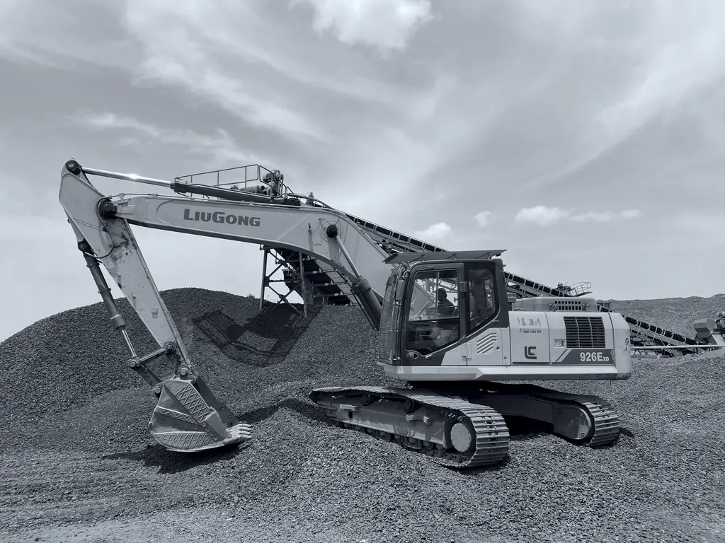 Hydraulic excavator positioned on a graded ore stockpile